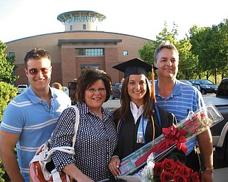 Melissa Bayus celebrates graduating with honors in May from Mercy College of Northwest Ohio with a degree in nursing. Pictured with her are, from left, her brother, Dan Bayus, Jr.; her mother, Lisa Bayus; and her father, Dan Bayus.