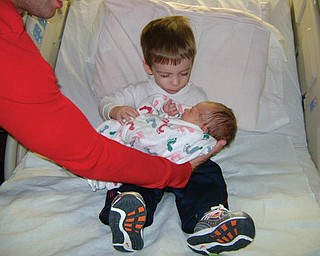 HI GUY! Big brother Shane Connolly, 2, meets his little brother, Brendan (born Nov. 9), for the first time. Brendan being held by Daddy Sean. The Connollys live in Austintown.