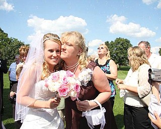 Doreen Knight hugs her daughter, the new Mrs. Noah (Ashley) Rupp, both of Canfield, after her wedding ceremony on Sept. 4.
