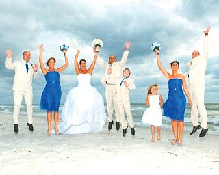 JUMPING FOR JOY: Celebrating the wedding of Wendi and Rob Spatar on Oct. 17 at Longboat Key, Fla., are, from left, Jeff Spatar of Howland, Juli Barnes of Girard, Wendi and Rob of Boardman, and Justin, Taylor, Sherrie and Anthony Spatar, all of Canfield.