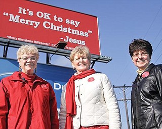 SENDING A MESSAGE: The Merry Christmas Billboard Ladies, from left, Joanne Brown of Poland, Pat See of Canfield and Linda Bennett of Niles, stand in front of one of their billboards at U.S. Route 422 and Robbins Avenue, Niles. Also in the group is Judi Hanna of Boardman. The billboard movement is catching on in other states.