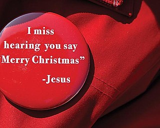 SIGN OF THE SEASON: Merry Christmas Billboard Ladies also wear and distribute buttons with the idea of keeping Christ in Christmas.