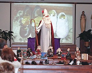CENTER STAGE: The legendary St. Nicholas of Myra appears at St. Nicholas Church in Struthers. Sunday’s service included prayer, songs, the filling of the shoes and the story of the candy cane.