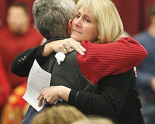 Condolences and hugs as the "Mooney Family" had a mass at the school to deal with the deaths of two seniors over the weekend.