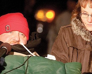 Joe Kaluza is interviewed by a television reporter alongside his sister, Anna Fitzgerald, during a Christmas lighting ceremony at the newly constructed home on Monday evening.