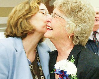 SAYING GOODBYE: Joyce Pogany, right, shares an embrace with her daughter, Pam Gent, at a reception to celebrate Pogany’s retirement after 28 years on the Austintown school board. Pogany was honored by family, friends and colleagues at a party before her final board meeting Monday.