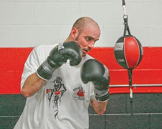 FOCUSED: Kelly Pavlik, shown here working out at the South Side Boxing Club in January, will hold an open workout at the gym today in preparation for his Dec. 19 bout at YSU.