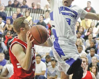CLIPPERS CLIPPED: Youngstown Christian’s Caleb Yanno (3) blocks a shot by Columbiana’s Zach Chaplow (32) during Tuesday’s game at Youngstown Christian High School. The Eagles defeated the Clippers, 93-71.