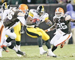 Pittsburgh Steelers running back Rashard Mendenhall, center, runs for four yards against Cleveland Browns linebacker Kaluka Maiava (56) and safety Abram Elam, right, in the first quarter of an NFL football game Thursday, Dec. 10, 2009, in Cleveland. (AP Photo/Mark Duncan)