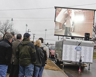 The Vindicator/Lisa-Ann Ishihara-- Kaluza family watches a video reel before entering their new house. Sunday December 13, 2009