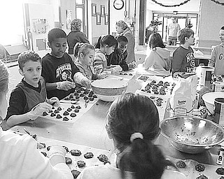 TASTY TREATS FOR TROOPS
Special to The Vindicator
GOOD COOKIES: Pupils in the fourth grade at St. Patrick School in Hubbard learned a valuable lesson in caring and sharing as they became involved in the Project Serving Soldiers led by Zack Lord of Hubbard, whose brother is serving in the Navy in Iraq. The goal of the project is to ship 300 dozen cookies to troops serving in foreign lands. The youngsters provided the ingredients and are pictured above as they spent part of a morning in the parish center making 15 dozen chocolate no-bake cookies for the troops. They worked on the project under the guidance of their teachers, Mrs. Sharisky and Mrs. Yambrovich, and volunteer parents. The pupils also sponsored a dress-down day and raised $145 to help pay the $10 shipping charge on each box of cookies.