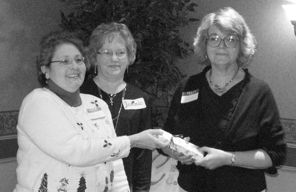 Special to The Vindicator
IT’S OFFICIAL: Niles Chapter of the American Sewing Guild celebrated the Christmas season at a party on Dec. 5 at Ciminero’s Banquet Center. Members took time during the festivity to elect officers who will serve during 2010. Named to various positions were Jennie Roberts, president; Lynn Price, first vice president; Barbara Rosier-Tryon second vice president; Diane Wittik, secretary; and Joan Dales, treasurer. A highlight of the event was the presentation of the organization’s first “Member of the Year” award. Above, from left, Wittik and Roberts begin their official duties by making the presentation to Rosier-Tryon in recognition of her significant contributions of time and talent to the guild.