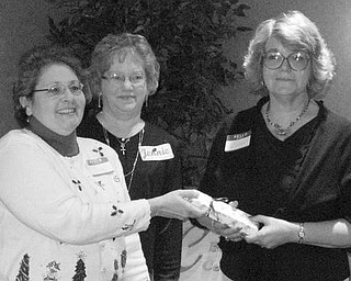 Special to The Vindicator
IT’S OFFICIAL: Niles Chapter of the American Sewing Guild celebrated the Christmas season at a party on Dec. 5 at Ciminero’s Banquet Center. Members took time during the festivity to elect officers who will serve during 2010. Named to various positions were Jennie Roberts, president; Lynn Price, first vice president; Barbara Rosier-Tryon second vice president; Diane Wittik, secretary; and Joan Dales, treasurer. A highlight of the event was the presentation of the organization’s first “Member of the Year” award. Above, from left, Wittik and Roberts begin their official duties by making the presentation to Rosier-Tryon in recognition of her significant contributions of time and talent to the guild.