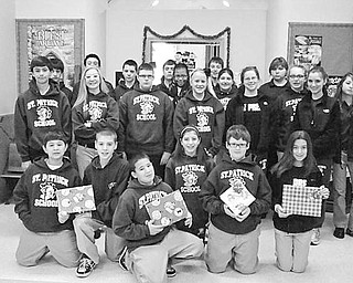 Special to The Vindicator
GIFT GIVERS: The Builders Club of St. Patrick School in Hubbard was dedicated this season to bringing holiday cheer to students at the Rich Center for Autism, on the campus of Youngstown State University. Club members, above, hold some of the gifts they purchased with their own money while shopping after school hours. The 20 gifts were wrapped and delivered to the center. Made up of seventh- and eighth-grade students at the school, the club is committed to helping fellow students and community members through service projects.