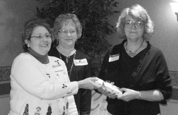 Special to The Vindicator
IT’S OFFICIAL: Niles Chapter of the American Sewing Guild had a Christmas party Dec. 5 at Ciminero’s Banquet Center. Members elected officers who will serve during 2010. Named to various positions were Jennie Roberts, president; Lynn Price, first vice president; Barbara Rosier-Tryon, second vice president; Diane Wittik, secretary; and Joan Dales, treasurer. A highlight was the presentation of the organization’s first “Member of the Year” award. Above, from left, Wittik and Roberts present the award to Rosier-Tryon in recognition of her significant contributions of time and talent to the guild.