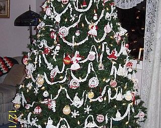 Judith Ferrett likes to crochet and decided to make all the ornaments for their Christmas tree, which includes angels, snowmen, bells, framed family pictures, strands of garland of faux pearls, snowflakes, candy canes, beaded icicles. She also crocheted the tree skirt. This is a work in progress as she adds to it each year.
