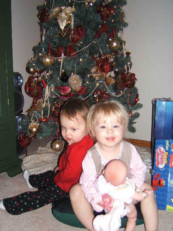 CHRISTMAS PRESENCE: Al and Diane Barnett of Austintown found their granddaughters under their tree. In front, Olyvia Rose Barnett, 18 months, is the daughter of Kevin and Miranda Barnett. Behind her is Savannah Marie Cervone, daughter of Michael and Lisa Cervone.
