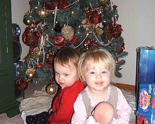 CHRISTMAS PRESENCE: Al and Diane Barnett of Austintown found their granddaughters under their tree. In front, Olyvia Rose Barnett, 18 months, is the daughter of Kevin and Miranda Barnett. Behind her is Savannah Marie Cervone, daughter of Michael and Lisa Cervone.