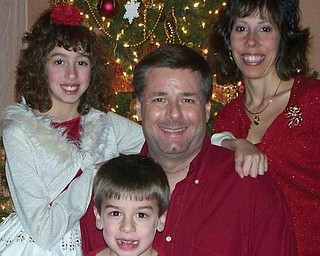 Darren, Maria, Katrina and Tyler Hayes of Poland pose in front of their living room tree on Christmas Eve.