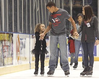 The Vindicator/Lisa-Ann Ishihara --- L-R Destini Gray (5) with her older brother Deven (14) Gray along with Veronica Dorbish (14) - all of Austintown - ice skate at the Covelli Centre for First Night Youngstown 2010