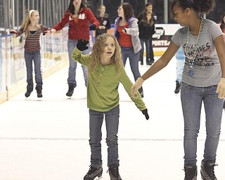 The Vindicator/Lisa-Ann Ishihara ---L-R Olivia Vaupel of Fowler Township and her friend Jahnai Bridges (12) of Orlando, FL- ice skate at the Covelli Centre for First Night Youngstown 2010