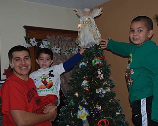 Renee Bero says this picture was taken the evening her grandsons, Jay, Alex and Santino Jorge of Struthers, placed the angel on top of their family Christmas tree.