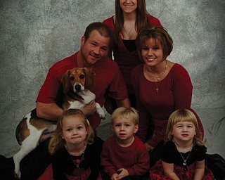 In this Bowers family pyramid (resembling a tree, of course) are, front from left, Brelyn, 4, Hadyn, 2, and Kaelyn, 2; middle, Brandon (father), holding Trinity, the family puppy, and Jackie (mother); and, top, Victoria Reighart (Jackie’s sister).