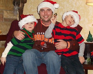 Nicholas and Nathan Burgermyer of Warren are pictured with their uncle, Craig Bash, at the home of another uncle, Jason Burgermyer, in Bazetta on Christmas Eve. They are the great-grandsons of Barb Bradford.