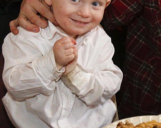 The Vindicator/Lisa-Ann Ishihara -- Bobby Cline (2) of Warren enjoys the holiday feast at Aulizio's Banquet Center in Warren for the free christmas dinner