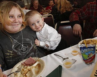 The Vindicator/Lisa-Ann Ishihara -- Tiffany Cline (12) and Bobby Cline (2) of Warren enjoy the holiday feast at Aulizio's Banquet Center in Warren for the free christmas dinner***Tiffany is not Bobby's sister.. I believe she is his aunt**