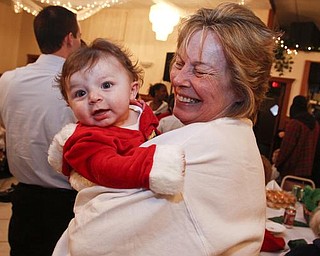 The Vindicator/Lisa-Ann Ishihara -- Aiden Strawderman (5 months) of Warren waits in his grandma's arms Betty Strawderman of Warren to see Santa at Aulizio's Banquet Center in Warren