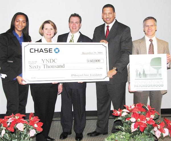 BANK GIVES BUCKS: JP Morgan Chase Bank donated $60,000 to Youngstown Neighborhood Development Corp.’s homeownership and Lots of Green programs. YNDC was launched in February 2009 in partnership with the city of Youngstown and Raymond John Wean Foundation. From left are Cinnamon Pelly, Deborah Eppinger and James Pitzer, all of JPMorgan Chase; Presley Gillespie, YNDC executive director, and George Garchar of YNDC.