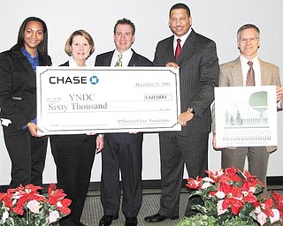BANK GIVES BUCKS: JP Morgan Chase Bank donated $60,000 to Youngstown Neighborhood Development Corp.’s homeownership and Lots of Green programs. YNDC was launched in February 2009 in partnership with the city of Youngstown and Raymond John Wean Foundation. From left are Cinnamon Pelly, Deborah Eppinger and James Pitzer, all of JPMorgan Chase; Presley Gillespie, YNDC executive director, and George Garchar of YNDC.