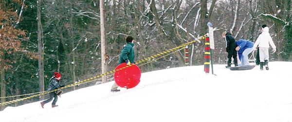 SNOW FUN: Children don’t drive in snow, but they do like to go sled riding, and a popular spot to do so is the sledding hill at Mill Creek MetroParks’ James L. Wick Recreation Area on Youngstown’s West Side. The new year has produced a lot of the white stuff, but forecasters predict near-normal temperatures and below-average precipitation totals for the first three months of 2010.
