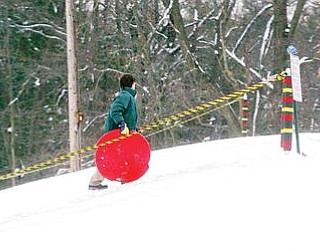 SNOW FUN: Children don’t drive in snow, but they do like to go sled riding, and a popular spot to do so is the sledding hill at Mill Creek MetroParks’ James L. Wick Recreation Area on Youngstown’s West Side. The new year has produced a lot of the white stuff, but forecasters predict near-normal temperatures and below-average precipitation totals for the first three months of 2010.