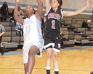 TRY FOR TWO: Chelsea Bennett (23) of East drives to the basket as Campbell’s Tashira Uceta defends during Monday’s game at East High School.