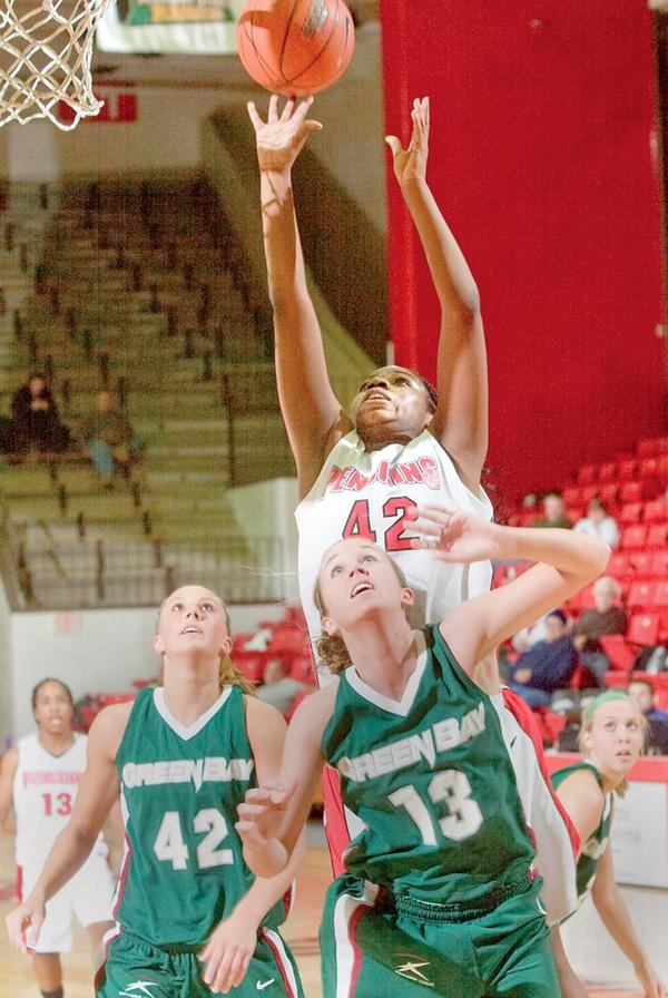 SECOND EFFORT: Youngstown State’s Brandi Brown (42) rises above Green Bay’s Kayla Tetschlag (42) and Adrian Ritchie (13) during the first half of Monday night’s game at YSU’s Beeghley Center. Brown finished with a team-high 16 points and nine rebounds — one short of earning her fifth double-double.