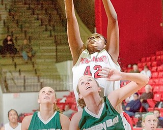 SECOND EFFORT: Youngstown State’s Brandi Brown (42) rises above Green Bay’s Kayla Tetschlag (42) and Adrian Ritchie (13) during the first half of Monday night’s game at YSU’s Beeghley Center. Brown finished with a team-high 16 points and nine rebounds — one short of earning her fifth double-double.
