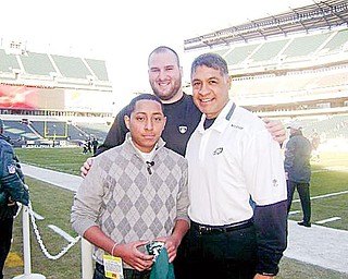 SPECIAL TRIP: Angelo Astorga, left, traveled to Philadelphia to see an Eagles game Dec. 27. While there, he got to meet some players. With him is Eagles offensive lineman Mike McGlynn, center, and the team’s offensive line coach Juan Castillo.