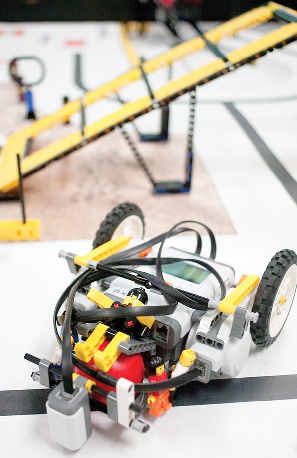 A WINNER: Lizzy the robot, made of Legos and guided by a microcontroller, won the Quality Design Award for the Lego Lizards of Girard Junior High School during regional robotics competition in Canton. The small ball in the front of the robot enhances Lizzy’s maneuverability.
