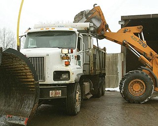 SALT CENTRAL: Road salt is placed into a Mahoning County plow truck at the county engineer’s department complex on Industrial Road.