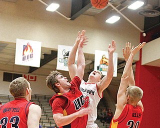 SEASON HIGH: Youngstown’s State’s Vytas Sulskis (44) shoots over UIC defenders Jeremy Buttell (33), Spencer Stewart (25) and Anthony Kelley (20) during the first half of Thursday’s game at Beeghly Center. Sulskis tied a season-high 17 points in the Penguins’ 76-67 win over the Flames.
