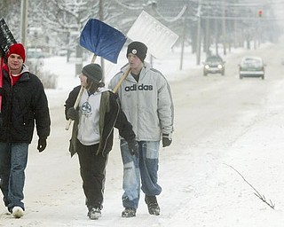 Off in search of driveways to shovel are: (Left to right) Gene Spitler, Thomas Newsome ad his brother Richard Newsome, all of Campbell.