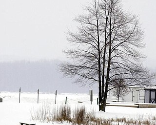 A lone picnic bench covered in snow and cold at Mosquito Lake State Park in Cortland.