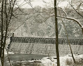 The Vindicator/Robert K. Yosay -----
Breath of winter as water flows over the damn near the Pioneer Cabin in Mill Creek MetroParks. with snow covering the evergreens.