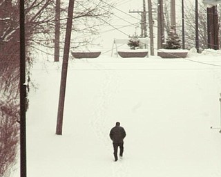 The Vindicator/Robert K. Yosay -----
A lone pedestrian makes his way up North Walnut in Youngstown as cold and snow blanketed the Youngstown Area.