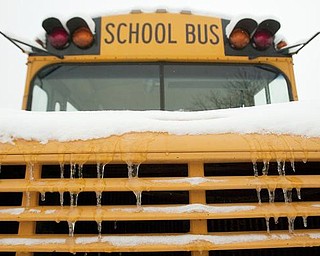 The Vindicator/Geoffrey Hauschild
A parking lot full of snow covered buses at the Youngstown Board of Education's Bus Depot on Friday afternoon.