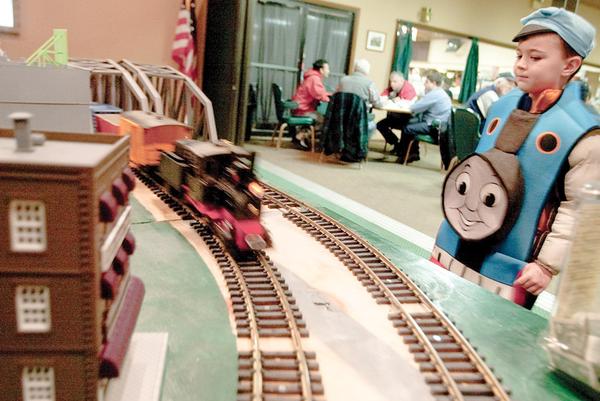 Wearing a Thomas the Tank Engine outfit, Bryce Pavlov, 4, of Poland, watches a model train rush past during the train show at McMenamy's on Sunday afternoon. 