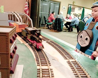 Wearing a Thomas the Tank Engine outfit, Bryce Pavlov, 4, of Poland, watches a model train rush past during the train show at McMenamy's on Sunday afternoon. 