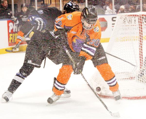 ON THE BRIGHT SIDE: Youngstown Phantoms’ Andrew Lamont (20) and Alex Lippincott (11) of the Fargo Force fight for the puck when the teams met Friday in the first of two games over the weekend at  the Covelli Centre. The Phantoms lost both matches, but Lamont was a bright spot in Saturday’s contest, scoring both goals of the night to give him eight for the year.
